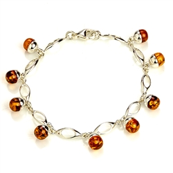 9 round amber beads each set in a sparkling sterling silver base. 7" - 18cm long.