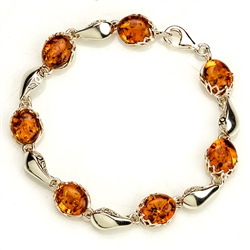 7 oval amber beads each set in a sparkling sterling silver frame. 7" - 18cm long.