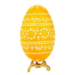 This beautifully designed egg is dyed one color then white wax is melted and applied to form an intricate design which is left on the surface. The egg is emptied. Stand not included.