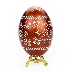 This beautifully designed egg is dyed one color (dark green) then white wax is melted and applied to form an intricate design which is left on the surface. The egg is emptied. Stand not included.