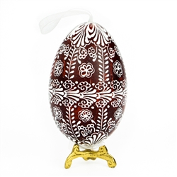 This beautifully designed egg is dyed one color, then white wax is melted and applied to form an intricate design which is left on the surfce. The egg is emptied and strung with ribbon for hanging or you can remove the ribbon.  This is the work of master