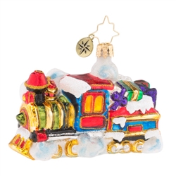 With wreaths of emerald, this shiny prize chugs along through snow drifts with its precious cargo of freshly wrapped gifts. Choo-choo!