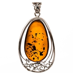 Sterling Silver with filigree detail surrounding a beautiful honey amber cabochon.