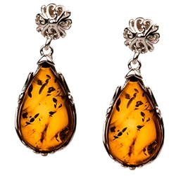 Gorgeous Baltic Amber oval stud earrings surrounded with a ring of Sterling Silver filigree work. Approx .75" long x .5" wide.
