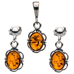 Petite Baltic Amber oval stud earrings and pendant set surrounded with a ring of Sterling Silver filigree work. Approx .75" long x .375" wide.