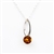 Artistic sterling silver pendant and adjustable length chain, surrounding a honey amber sphere.