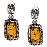 Gorgeous Baltic Amber stud earrings surrounded with a ring of antique style sterling silver. Size approx .75" x ..375.