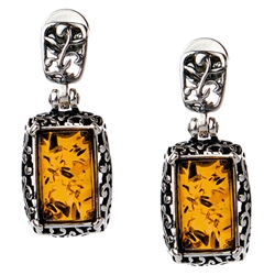 Gorgeous Baltic Amber stud earrings surrounded with a ring of antique style sterling silver. Size approx .75" x ..375.
