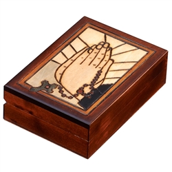 The lid of this beautiful box is decorated with a depiction of praying hands holding a rosary.