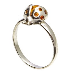 Silver and Amber Ladybug resting on a sterling silver band.
