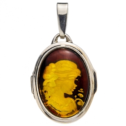 Beautiful oval shaped sterling silver amber cameo locket. The cameo is hand carved from the back of the pendant. Nicely detailed. Size is approx 1.2" x .6". (closed)