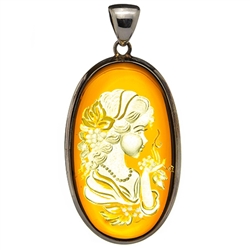 Beautiful oval shaped sterling silver amber cameo pendant. The cameo is hand carved from the back of the pendant. Nicely detailed.  Size is approx 1.25" x 2.5".