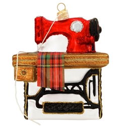 Sew charming is our sewing machine ornament! Measuring 4.5" tall, our nostalgic ornament features the vintage sewing machine of yesteryear with a piece of plaid ribbon draping down and a dangling crme thread wrapped around the topper. Crafted in Poland