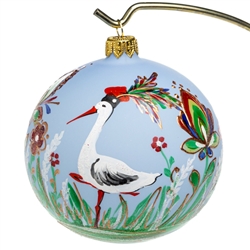 Celebrate your unique heritage with this distinctive ornament depicting Poland's favorite seasonal visitor...the stork.  Our stork is wearing a Krakowiak hat and is surrounded by beautiful folk flowers.