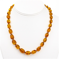 Delicate honey amber beads rounded and knotted between each bead.  Beads are about .5cm in diameter.