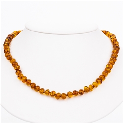 Delicate honey amber beads rounded and knotted between each bead.  Beads are about .5cm in diameter.
