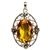 Sterling Silver with filigree detail surrounding a beautiful diamond cut honey amber cabochon.  Size is approx 2.2" x .1.4" x .5".