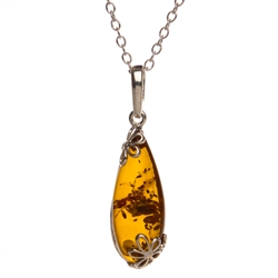 Sterling Silver with antique detail highlighting a beautiful honey amber cabochon.  Amber cabochon size is 1" x .5".