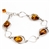 4 tear drop shaped amber beads each set in a sterling silver frame. Size is 7.5" diameter with a 1" extender.