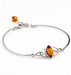 This sterling silver bracelet features a marquis shaped center of honey amber. Size is 7" diameter with a 1" extender.