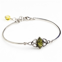 This sterling silver bracelet features a marquis shaped center of green amber.  Size is 7" diameter with a 1" extender.