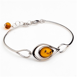 This sterling silver bracelet features a gorgeous center of honey amber.  Size is 7" with a 1" extender.