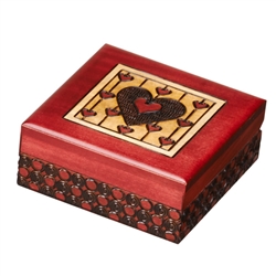 This box is decorated with multiple hearts on the lid and circular detailing around the sides. Finished a red stain.
