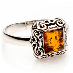 Honey colored amber and sterling silver filigree ring. Size approx. .4" square.