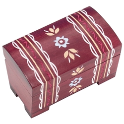 Mountain Chest Wooden Box. This warm colored box is a chest style with a footed base. A handcarved zig-zag and banded pattern wraps over the top from the back to the front.