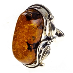 A beautiful honey amber cabochon framed in a classic sterling silver frame. Size is approx 1.4" x .1".