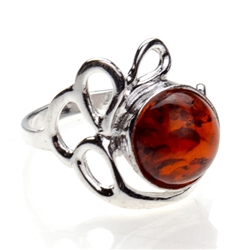 Artistic Round Honey Amber And Silver Ring. A nice size amber cabochon framed in a classic sterling silver frame.