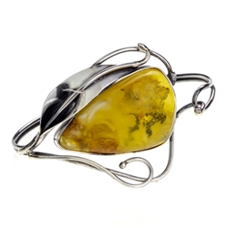 This sterling silver bracelet features a gorgeous amber cabachon in an artistic silver frame.. Bracelet Size is 7.25" diameter.  Cabochon size is approx 1" x 1.5".