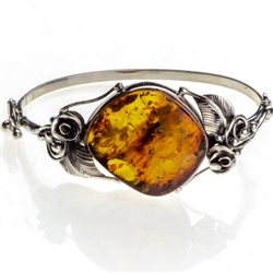 This sterling silver bracelet features a gorgeous dark honey amber cabochon.. Bracelet size is 7.25" diameter.  Cabochon size is approx 1" x 1.25".