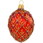 Shimmering in a vivid hue of ruby red with eye-catching accents, this stunning hand-painted ornament was inspired by the famous jeweled eggs of the House of Faberge, in St. Petersburg, Russia. A sparkling gold glitter diamond pattern with purple and