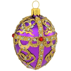 An egg-ceptional choice for the tree, this dazzling glass ornament was inspired by the famous jeweled eggs of the House of Faberge, in St. Petersburg, Russia. Featuring sparkling glitter folk patterns and glistening gold lines studded with eye-catching