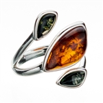 Artistic sterling silver ring highlighting three amber cabochons.  Size is approx 1" x .75".