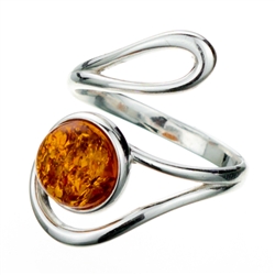 Amber cabochon set in a stylish swirl of silver.  Amber cabochon is approx .4" x .4".