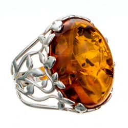 Golden honey amber cabochon framed in a leafy silver setting.  Cabochon is approx .8" x .6".