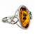 Silver band with a Celtic design showcasing a honey amber cabochon.  Cabochon size is approx .6" x .4".