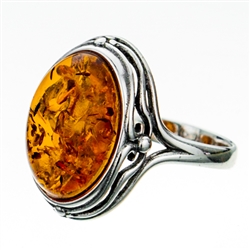 Classic oval shaped amber cabochon set in sterling silver.  Size is approx .75" x .5".