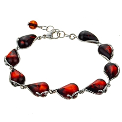 9 elegant drops of cherry amber each set in sterling silver . Bracelet is 8" long and adjustable smaller.