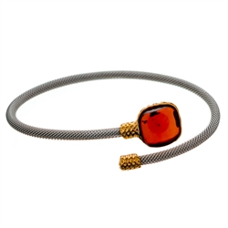 This is a simple yet elegant design wrap a round flexible bracelet with a cherry amber cabochon is a sterling silver gold plated frame.