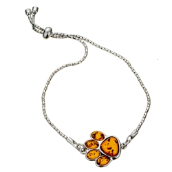 This adjustable sterling silver bracelet features a silver and amber paw print. Bracelet can be adjusted to a maximum 8.5" diameter.