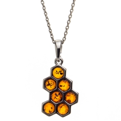 Sterling silver honeycomb filled with beautiful honey amber drops. Pendant size is approx. 1" x .5".