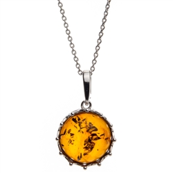 A sterling silver crown is the frame for this beautiful round honey amber cabochon.  Pendant size is approx. 1" x .75".