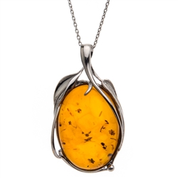 Artistic Sterling silver frames a beautiful honey amber cabochon drop. Cabochon size is approx. 1.25" x 1".