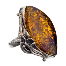 A beautiful amber cabochon framed in a classic sterling silver frame. Size is approx 1.25" x 1".