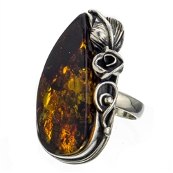 A beautiful amber cabochon framed in a classic sterling silver frame. Size is approx 1.25" x .8".