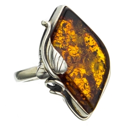 A beautiful amber cabochon framed in a classic sterling silver frame. Size is approx 1.25" x 1".