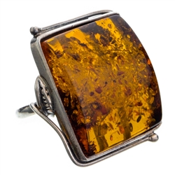 A beautiful amber cabochon framed in a classic sterling silver frame. Size is approx 1.25" x 1".